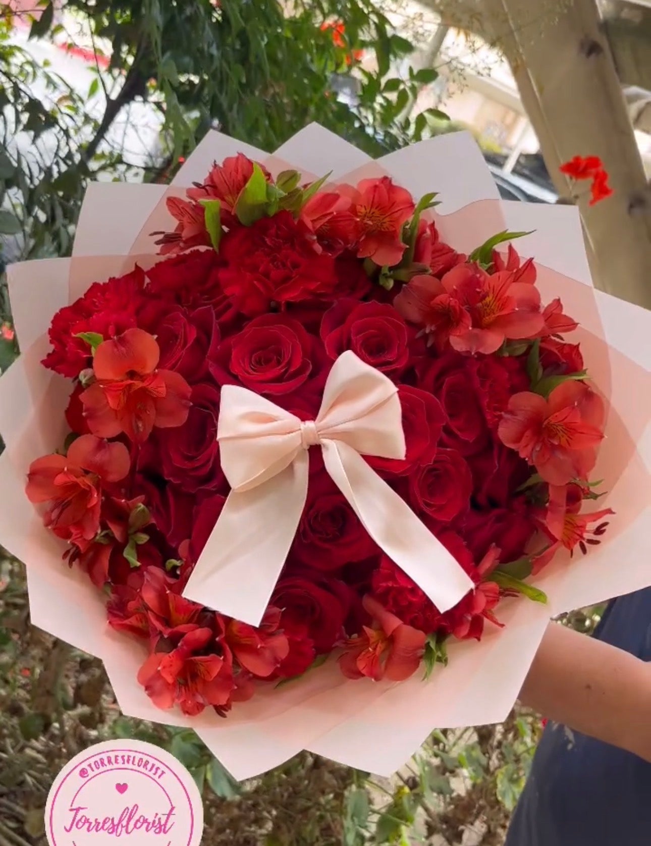 Large red rose and alstroemeria bouquet with cream bow and white wrapping